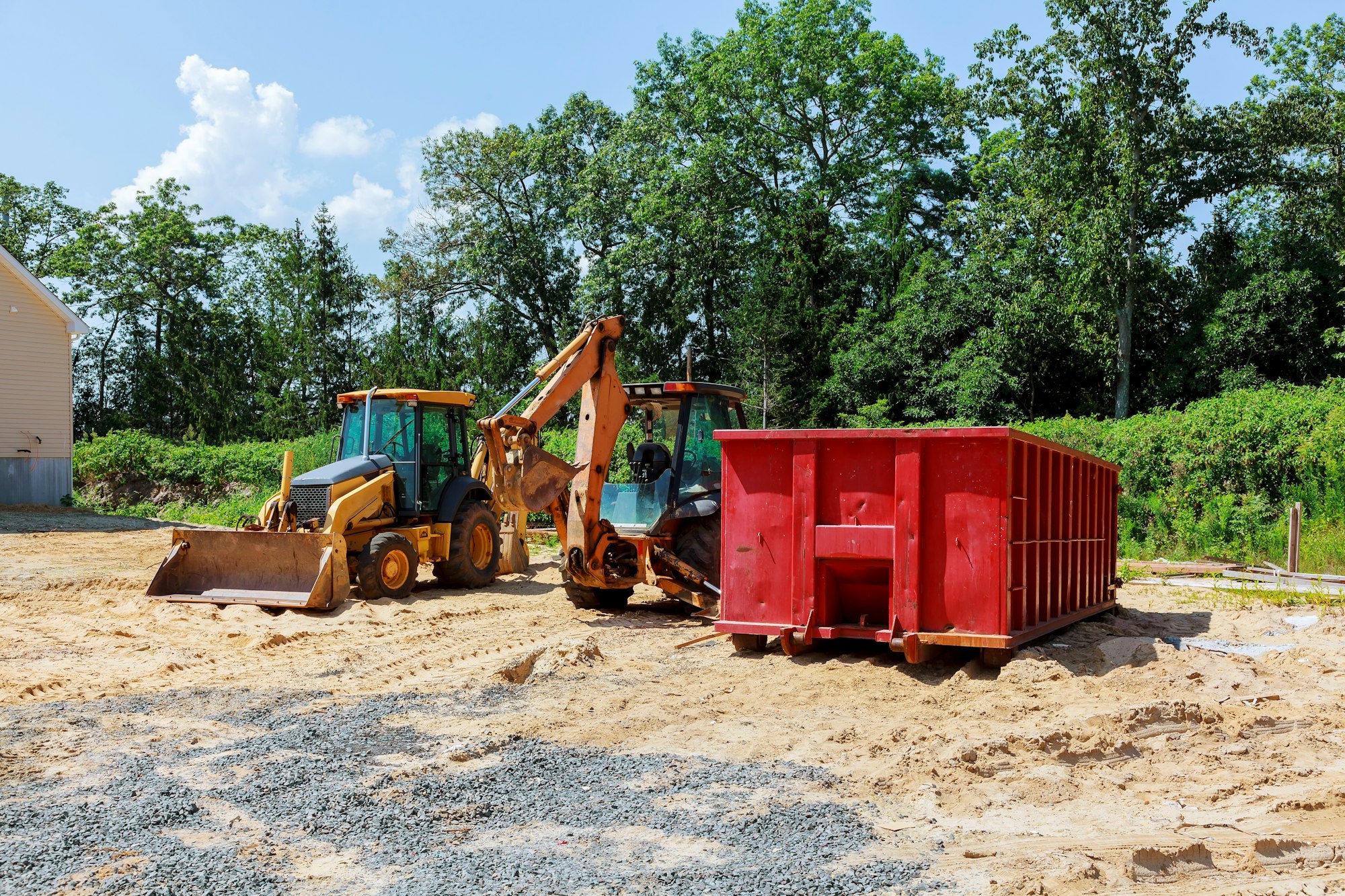 Yellow Excavator at Construction new tractor excavators and garbage containers